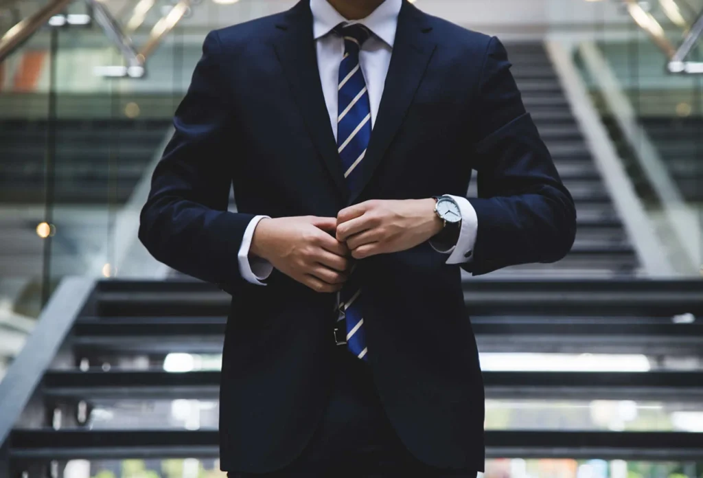 Hero Banner Image of a man infront of stairs dressed in a suit